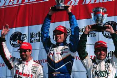 Andretti, Moore and Franchitti celebrate. Michael L. Levitt / LAT Photographic