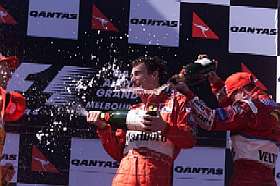 Eddie Irvine celebrates a deserved first-ever GP win