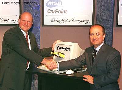 Jacques Nasser, President and CEO of Ford Motor Co. and Steve Ballmer, President of Microsoft Corp. shake hands
